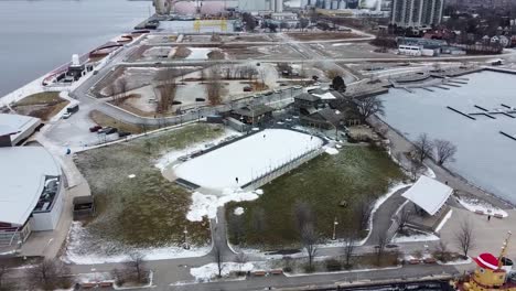 Drone-circling-over-a-hockey-rink-next-to-a-harbor-in-Hamitlon