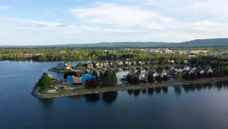 Drone-circling-over-houses-built-on-a-lake-peninsula-in-Collingwood