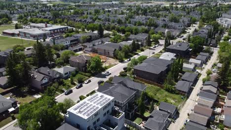 Drone-flying-over-new-houses-near-a-school-on-a-sunny-day-in-Calgary