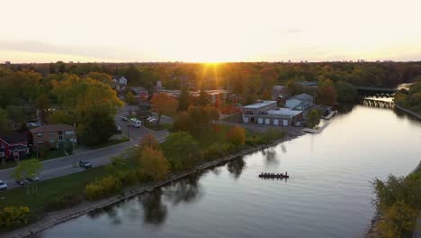 Flying-over-a-Mississauga-river-with-rowers-on-it-at-sunrise