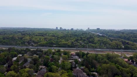 Drone-flying-toward-QEW-in-Mississauga-with-Lake-Ontario-in-the-distance