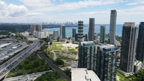 Aerial-shot-of-apartment-buildings-on-the-lakeshore-of-Lake-Ontario-with-the-Gardiner-Expressway-running-past