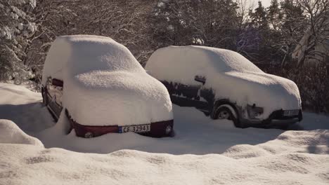 Vehicles-Parked-Outdoor-Covered-With-Dense-Snow.-Sideways