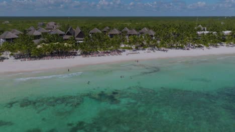 Tourists-in-Tropical-Waters-by-Beach-in-Tulum,-Mexico---Aerial