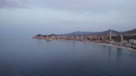 Benidorm,-Spain-Mediterranean-Coastline-during-Calm,-Evening-Sunset---Aerial