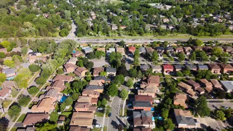 Flying-over-Mississauga-houses-with-traffic-on-the-road-below