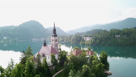Aerial-shot-pulling-away-from-a-church-on-an-island-in-Slovenia