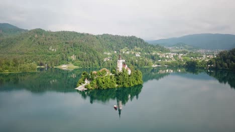 Drone-shot-rising-with-Assumption-of-Maria-Church-in-the-middle-of-Lake-Bled-in-Slovenia