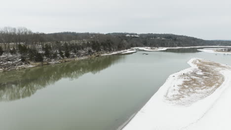 Flying-Over-The-Tranquil-Waters-Of-River-In-Daytime-During-Winter-In-Arkansas,-USA