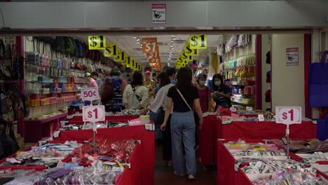 Shoppers-shops-at-the-one-dollar-retail-shop-in-Chinatown,-Singapore