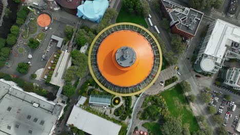 Rising-top-down-drone-shot-of-the-Space-Needle-while-it-was-painted-orange-in-honor-of-its-60th-Anniversary