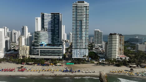 Aerial-view-in-front-of-the-beach-and-high-rise-of-Bocagrande,-in-sunny-Cartagena,-Colombia---tracking,-drone-shot
