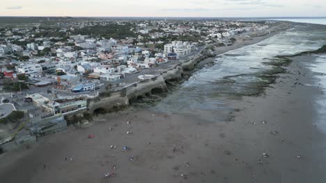 Aerial-Drone-Fly-Above-Travel-Beach-Destination-Las-Grutas-Patagonia-Argentina,-Summer-Season,-City-Architecture-and-Caves-View