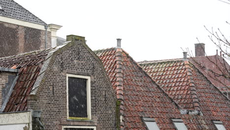 Snow-Falling-On-Brick-Stone-Roofs-Of-Typical-Architectures-In-The-Old-City-Center-Of-Gouda-In-The-Netherlands