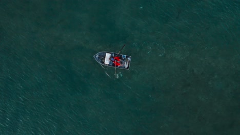 birdseye-view-of-fishermen-rowing-boat-against-outgoing-tide
