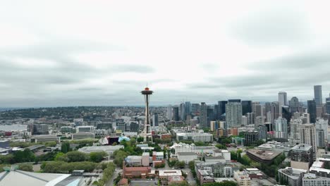 Wide-establishing-aerial-view-of-the-Seattle-Space-Needle-looming-over-the-surrounding-buildings