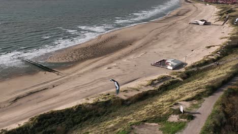 Paragliders-soar-and-swerve-along-coastal-dunes-of-Zoutelande,-Netherlands