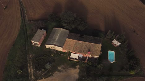 A-drone-shot-going-down-approaching-a-country-house-in-Girona,-Spain