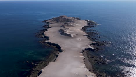 Orbit-around-Bahia-Asuncion-sea-cliff-peninsula-with-deep-blue-water-surrounding