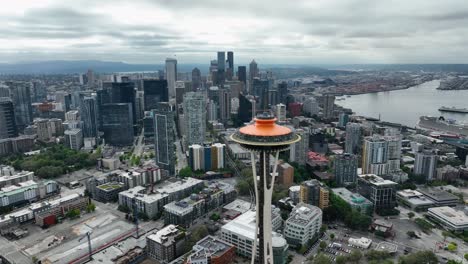 Große-Luftaufnahme-Der-Seattle-Space-Needle-Mit-Den-Wolkenkratzern-In-Der-Innenstadt,-Die-In-Der-Ferne-Aufragen