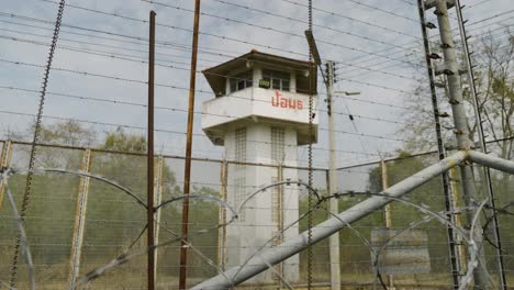 Prison-Watch-Tower-with-Barbed-Wire-and-Razor-Wire-Fence-inside-Jail-Prison,-High-Security-Prison