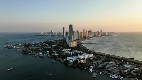 Aerial-view-of-the-Bocagrande-district,-sunny-evening-in-Cartagena,-Colombia---tracking,-drone-shot