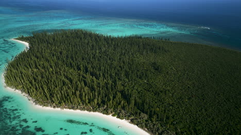 Pull-back-aerial-reveal-of-Brush-Island,-an-uninhabited-islet-in-the-Isle-of-Pines-archipelago