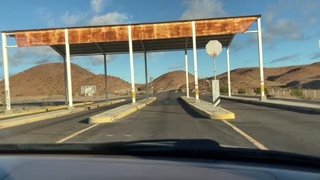 Deserted-checkpoint-in-dry-climate-passenger-side-POV-inside-car