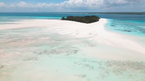 4K-flying-drone-footage-above-white-sandbanks-coast-with-beautiful-transparent-rippled-waves-washing-coral-reefs-atoll-near-Mnemba-Island,-Tanzania