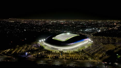 Drone-shot-around-the-night-lit-BBVA-stadium,-evening-in-Monterrey,-Mexico