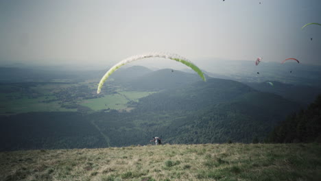 A-paraglider-is-taking-off-on-"puy-de-dôme"-in-france