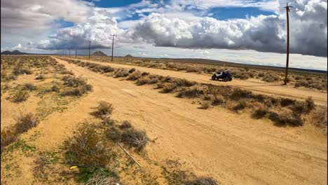 Following-an-ATV-dune-buggy-on-a-trail-in-the-Mojave-Desert-with-an-FPV-drone
