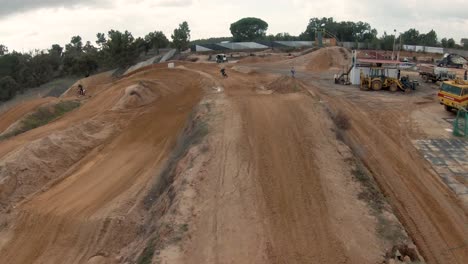 Motocross-circuit-with-ramps,-ups-and-downs-of-red-dirt