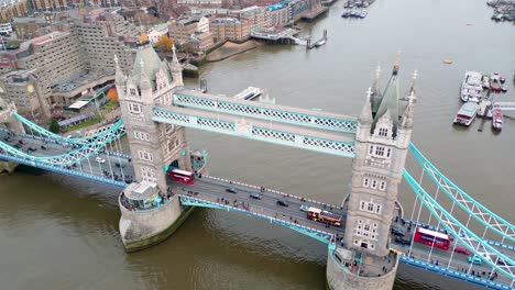 Dolly-in-tilt-down-drone-shot-of-the-Tower-Bridge-in-London,-England,-during-the-day