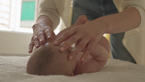 Mother-plays-with-baby-boys-arms,-hands,-caresses-newborn-child