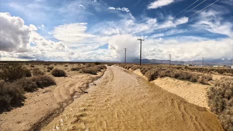 Unusual-monsoon-rains-in-the-Mojave-Desert-fill-Cache-Creek-with-water---aerial-flyover-reveal
