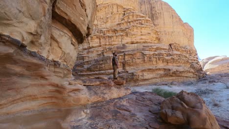 man-leaning-out-of-the-cliff-in-wadi-rum