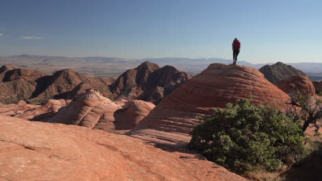 Female-Hiker-Climbing-on-Swirled-Rock-Formation-in-Utah-USA-Desert,-Yant-Flat-Candy-Cliffs-Hiking-Trail