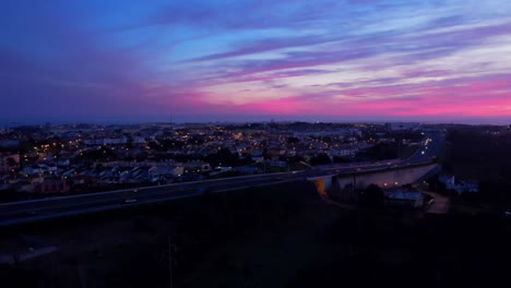 Drone-shot-of-beautiful-violet-sunset-in-Guincho-Cascais,-Portugal