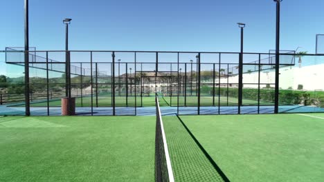 revealing-dolly-shot-along-a-padel-court-net-with-stunning-new-courts-on-display
