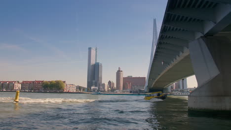 Motorboat-sailing-under-a-bridge