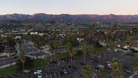 Aerial-shot-ascending-and-palm-trees-in-california-beach-parking-lot