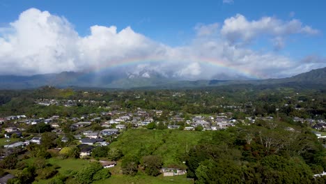 Cinematic-arial-view-of-rainbow-in-cloudy-sky-in-Kauai,-Hawaii,-USA