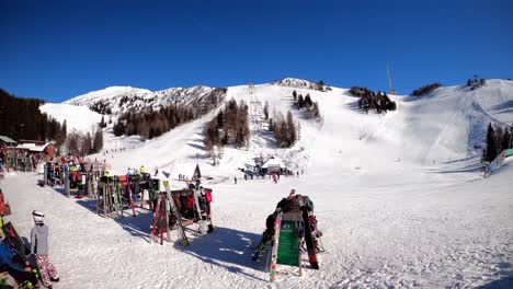 Timelapse-video-from-Slovenia,-Krvavec-ski-resort,-skiing-people-with-the-magnificent-hills-in-the-background-on-a-sunny-day