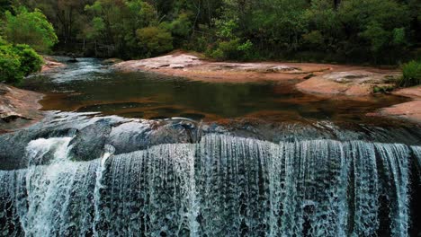Belmore-Falls,-Australia,-Drone-Reverse-Downward-Pan-of-Massive-Falls