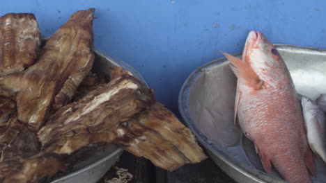 Close-up-and-pan-right-of-fried-shark-and-red-snapper-at-street-fish-market-in-Buenaventura