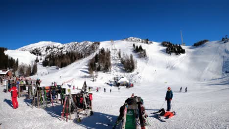 Slovenia,-Krvavec-ski-resort,-view-of-the-slopes-and-people-on-a-clear-and-sunny-day