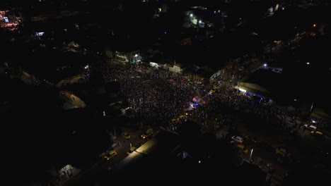 Aerial-view-around-Carnival-of-Barranquilla-celebrations,-night-in-Colombia---circling,-drone-shot