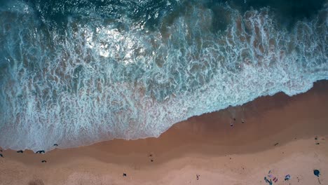 Aerial-Drone-Overhead-Flyby-Shot-of-Waves-Crashing-Onto-Beach