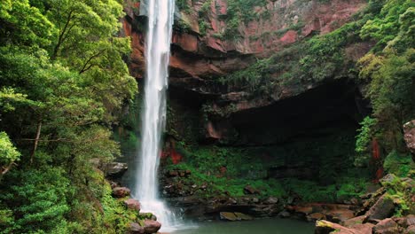 Belmore-Falls,-Australia,-Drone-Shows-Massive-Waterfall-Behind-Trees